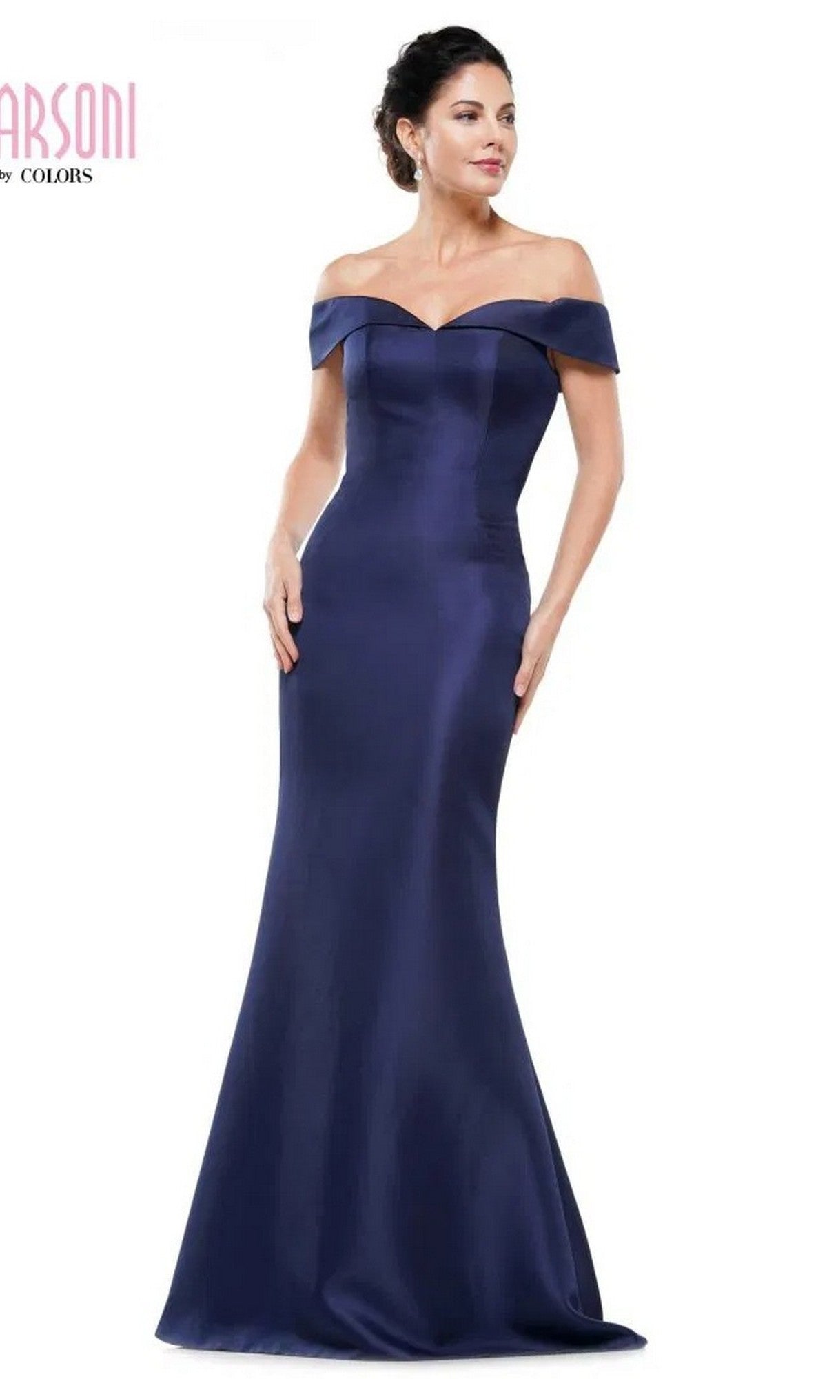 A woman wears the Marsoni MV1153 long formal dress in navy, featuring a fitted, off-the-shoulder design, standing against a white background.